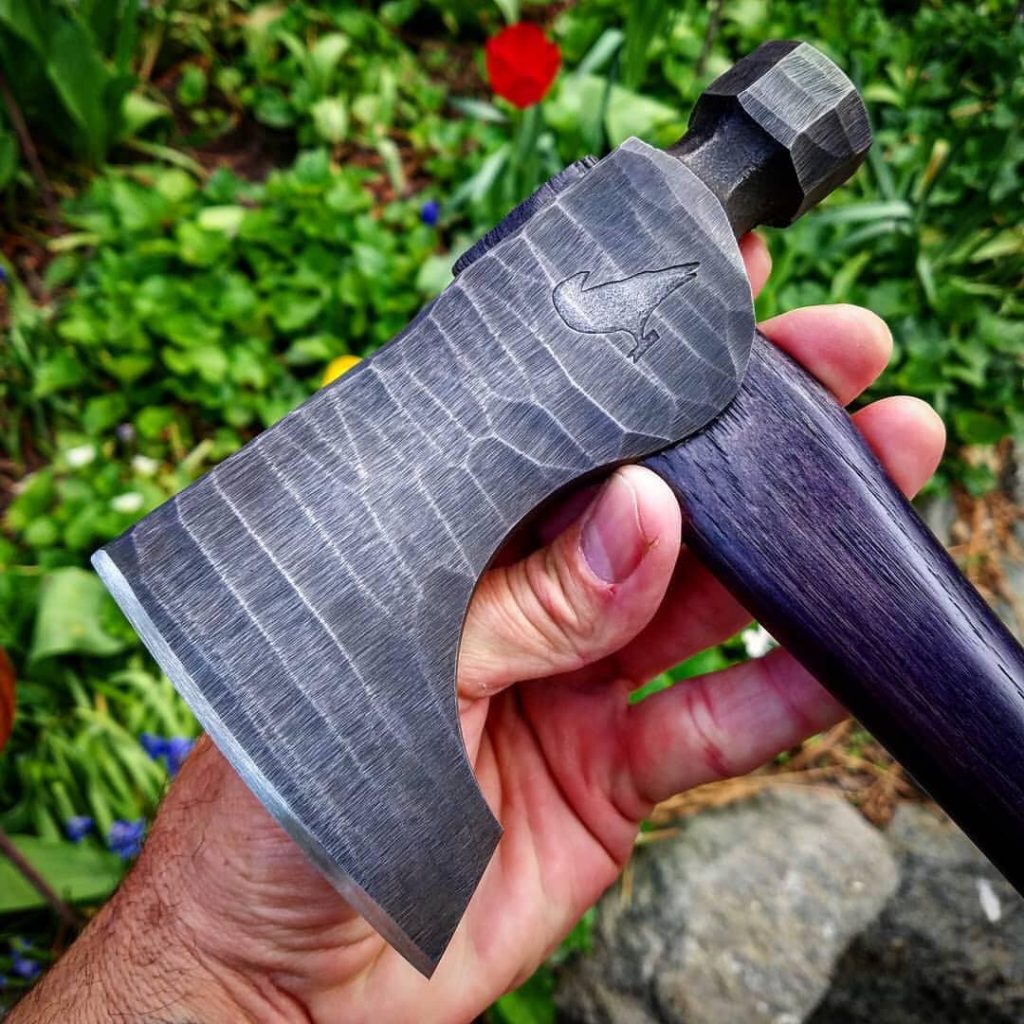 Close up of the raven-stamped axe head.