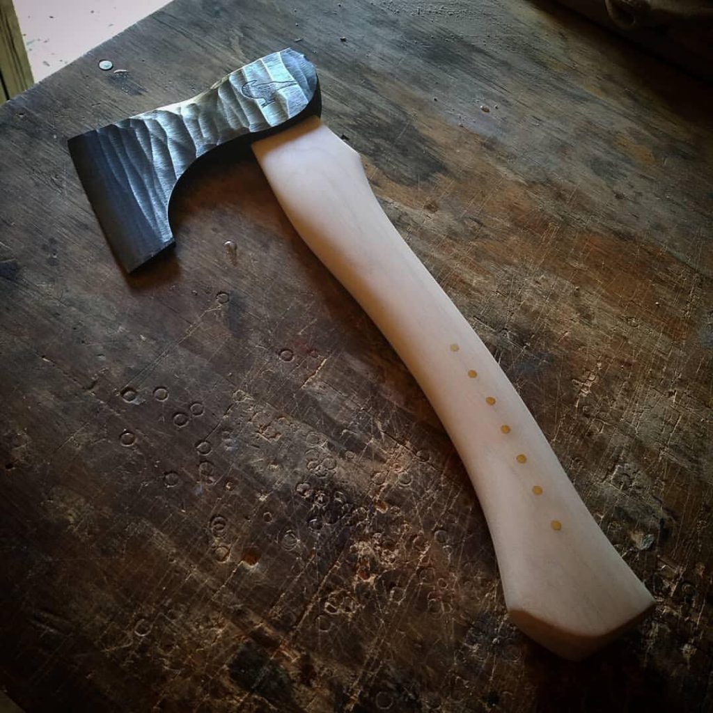 Handmade hand axe with a roughhewn axe head.