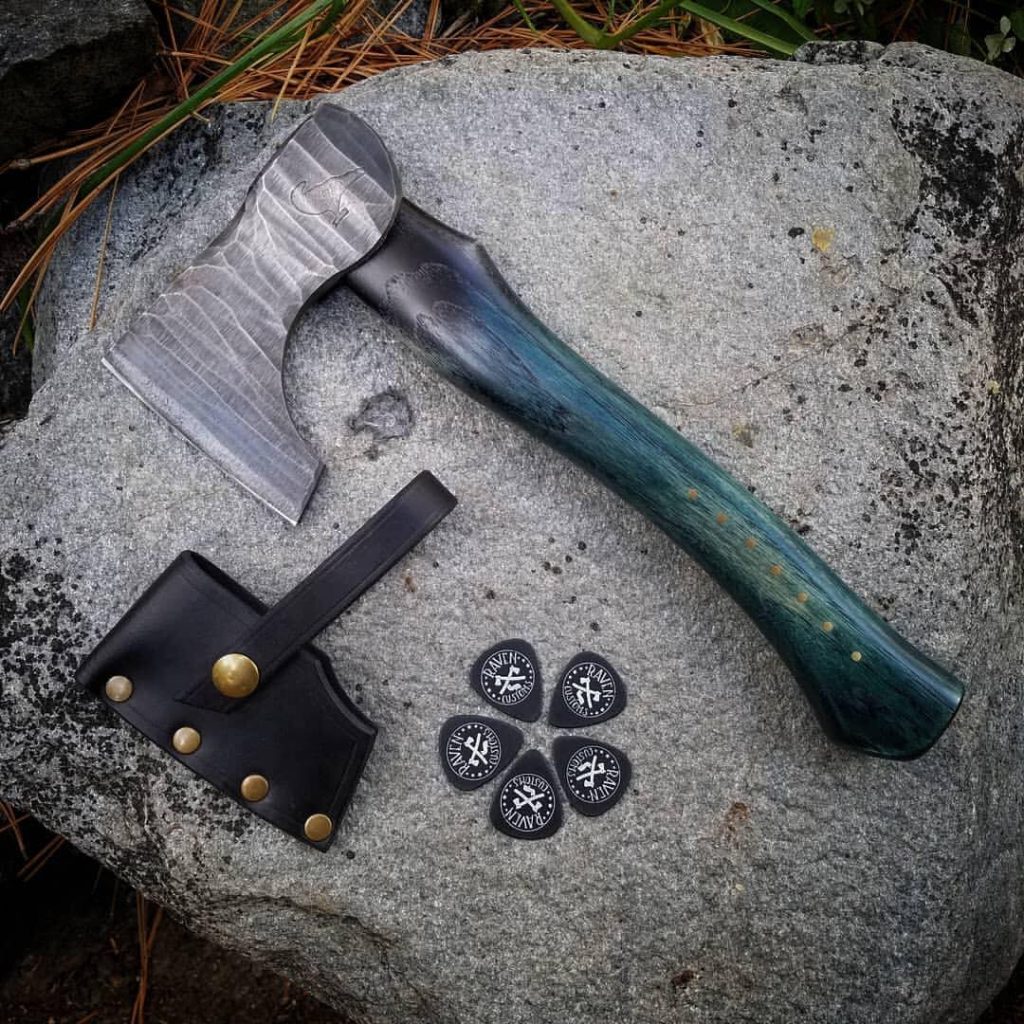 Roughhewn axe head with stained handle and leather cover.